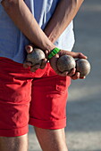 Man playing boules, Saint-Tropez, Var, Provence-Alpes-Cote d'Azur, France, Europe