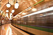 A Paris metro train leaves Cite station, Paris, France, Europe