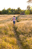 Mother and son (4 years) running to meet each other, Marielyst, Falster, Denmark