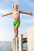 Boy (4 years) balancing on a jetty, Gedser, Falster, Denmark