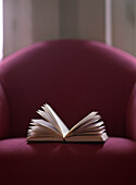 Open book on chair.