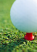 Teed golf ball, extreme close-up