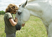 Boy kissing horse