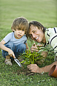 Father and son planting seedling