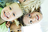 Children with heads together, low angle view
