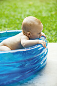 Baby in inflatable baby pool