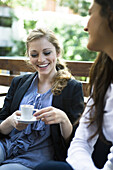 Young woman with friend at cafe