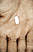 Single pill in hand