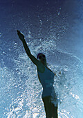 Young woman underwater, underwater view.