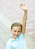 Girl raising hand, smiling