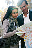 Couple consulting map outdoors