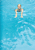 Young woman swimming in pool