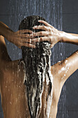 Woman washing her hair in shower