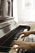 Woman's hands playing piano