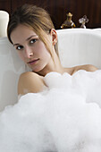 Woman relaxing in bubble bath, portrait