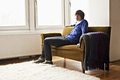 A teenage boy sitting on a couch