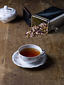 Herbal tea cup with saucer on wooden table