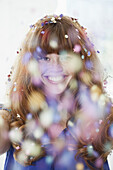 A grinning woman with falling confetti