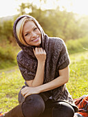 A woman wearing a shawl relaxing outdoors in the sun