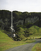 A waterfall in a lush landscape, Djupivogur, Iceland