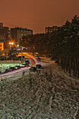 Long exposure shot of cars moving on a snowy street at night, Voronezh, Russia