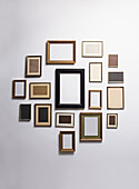 Various empty picture frames hanging on a wall