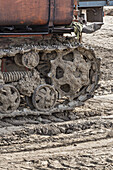 Rusted metal treads on a backhoe