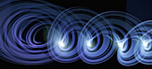 Blue purple light trails creating an abstract spiral pattern