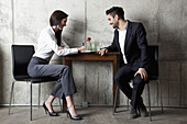 A businessman and businesswoman having a meeting in a modern office