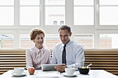 Business colleagues using a digital tablet during a business lunch