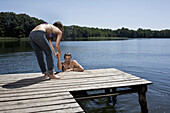 Fun as woman helps man out of the water on jetty