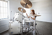 Girl plays drum kit