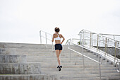 Girl jogging up steps