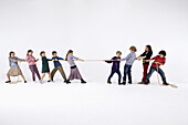 A group of kids playing tug-of-war