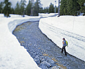 Female hiker walking through clear pathway on Mount Seymour, Vancouver, Canada