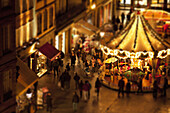 Tilt-shift of a crowd of people at a carousel at an outdoor festival, Strasbourg, France