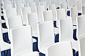 Rows of white chairs, close-up