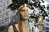 Mannequins looking at the street buildings