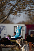 A blue cowboy boot at a flea market