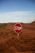 A stop sign at an intersection in a desert