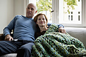 A mature couple relaxing on a sofa
