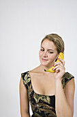 Woman on banana phone looking down