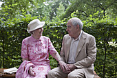 Romantic senior couple on bench in the park