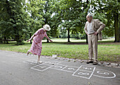 Senior couple play hopscotch