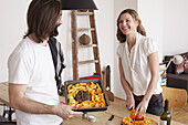 Smiling couple preparing pumpkin dish at home