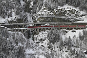 A train crossing a mountainside viaduct
