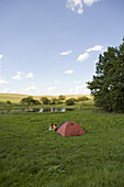 Distant view of people camping in field