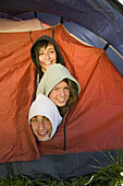 Three friends crowded inside tent