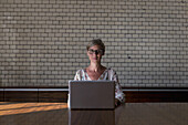 Woman with laptop, portrait