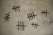 Counting with tally marks on wall, close-up